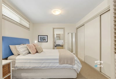 Bright and spacious bedroom featuring ample storage and an inviting atmosphere, perfect for relaxation.