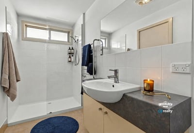 Modern bathroom featuring a spacious shower, sleek fixtures, and ample natural light, perfect for relaxation.