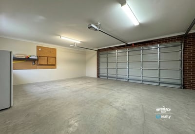 Spacious garage featuring ample storage options and abundant natural light, ideal for vehicles and projects.
