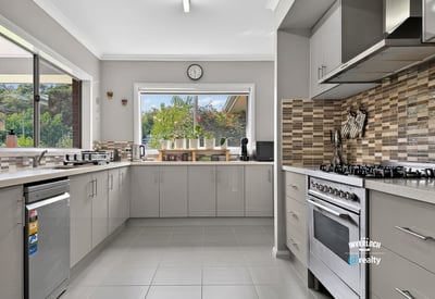Bright and functional kitchen featuring modern appliances and a scenic view through large windows.
