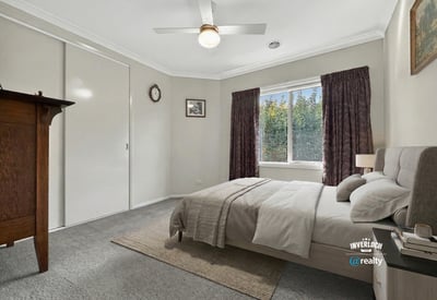 Bright bedroom featuring a cozy layout, large window, and ample storage for a comfortable living experience.