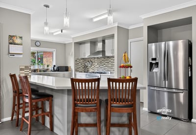 Modern kitchen featuring sleek appliances, ample counter space, and a breakfast bar perfect for gatherings.