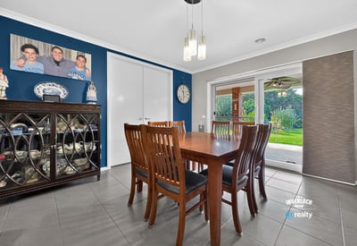Spacious dining area with direct access to a well-maintained backyard, perfect for gatherings and entertaining.