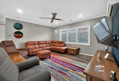 Spacious living area features contemporary furnishings and vibrant decor, perfect for relaxation and entertaining.