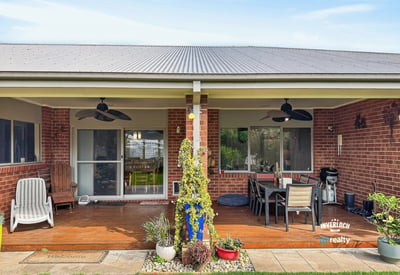 Spacious outdoor area with a covered patio, perfect for entertaining and enjoying the serene backyard.