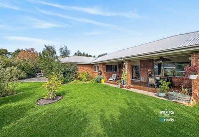 Spacious outdoor area surrounded by lush greenery, perfect for entertaining or enjoying peaceful afternoons.