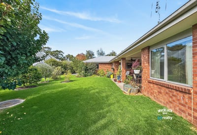 This well-maintained property features a spacious lawn and beautiful gardens, perfect for outdoor relaxation and gatherings.