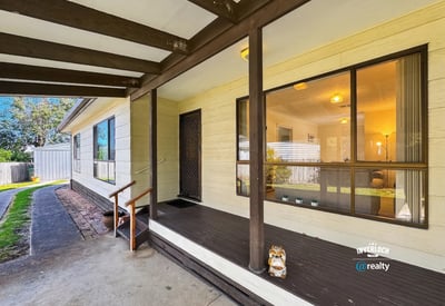 This inviting home features a spacious porch, perfect for relaxation and outdoor gatherings.