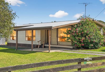 This inviting home features a spacious porch and well-maintained landscaping, perfect for outdoor relaxation.
