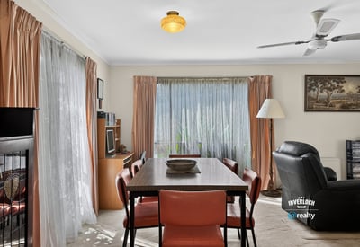 Bright and inviting living space featuring large windows, a dining area, and comfortable seating for relaxation.