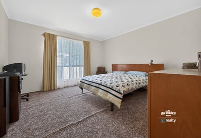 Spacious bedroom featuring large windows, ample natural light, and practical storage solutions for everyday convenience.