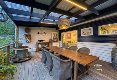 Spacious outdoor dining area with unique decor, perfect for gatherings and enjoying alfresco meals year-round.