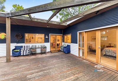 Spacious outdoor deck seamlessly connects to a cozy interior, perfect for entertaining and relaxation.
