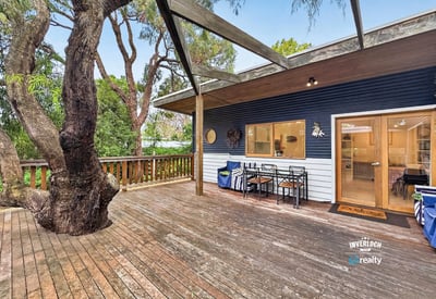 Spacious outdoor deck surrounded by nature, perfect for entertaining or relaxing in a tranquil setting.