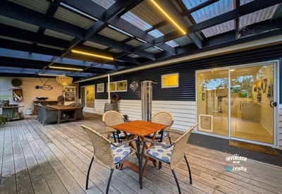 Inviting outdoor space featuring a covered patio and ample seating for leisure and entertainment.