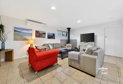 Bright and inviting living space featuring a cozy fireplace, modern furnishings, and ample natural light.
