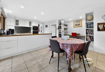 Bright and inviting kitchen and dining area, featuring modern finishes and ample storage space.
