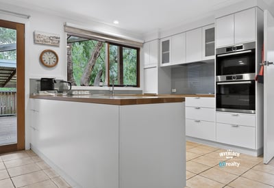 Modern kitchen featuring high-end appliances, ample storage, and large windows for natural light. Perfect for cooking enthusiasts.