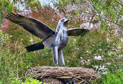 This property features a unique metal sculpture of a bird, adding artistic flair to the lush surroundings.