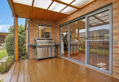 Enjoy outdoor entertaining on this spacious deck, featuring dual BBQs and easy access to the interior.