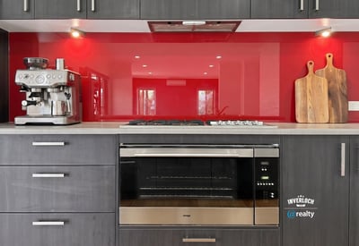 Modern kitchen featuring sleek cabinetry, a vibrant backsplash, and high-end appliances for culinary enthusiasts.