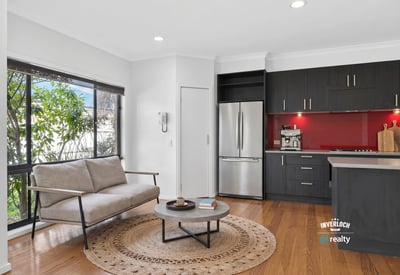 Modern kitchen and inviting living area with natural light, perfect for comfortable daily living.