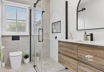 Modern bathroom featuring sleek lines, a spacious shower, and ample natural light for a refreshing ambiance.