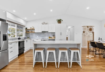 Bright, open kitchen with modern appliances, spacious island, and inviting dining area for entertaining.