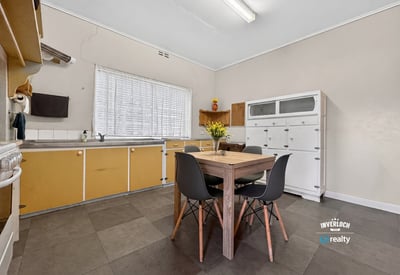 Bright, functional kitchen featuring ample storage and a cozy dining area, perfect for everyday meals.