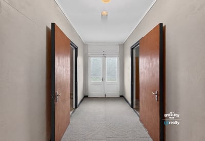 Spacious entrance featuring double doors, leading to sunlit rooms and versatile layout opportunities.