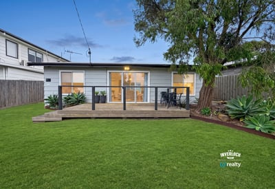 This inviting home features a spacious backyard and modern deck, perfect for outdoor gatherings and relaxation.