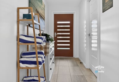 Bright and welcoming entryway featuring modern decor and practical storage solutions for your convenience.