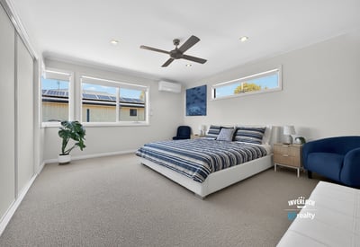 Bright and spacious bedroom featuring large windows, modern amenities, and a comfortable atmosphere for relaxation.