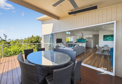 Experience seamless indoor-outdoor living with this inviting patio and expansive views of the surrounding greenery.