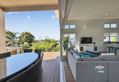 Bright and spacious indoor-outdoor living area with scenic views, perfect for entertaining and relaxation.
