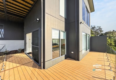 Contemporary design meets outdoor space in this inviting home with expansive decking and bright living areas.
