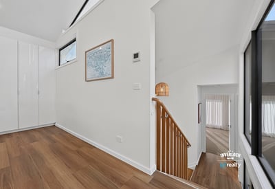 Bright and open foyer with modern design, leading to spacious living areas and stylish staircase.