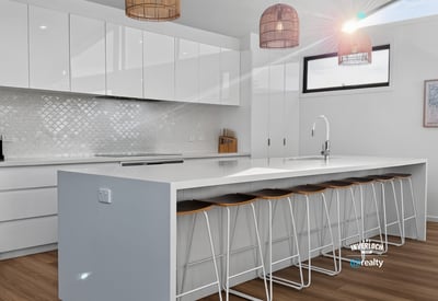 Bright, modern kitchen featuring sleek cabinetry, a spacious island, and inviting seating for social gatherings.