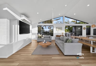 Bright and airy living space with large windows offering stunning views and seamless indoor-outdoor flow.