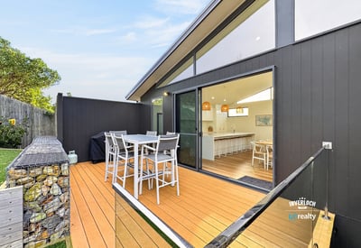 Spacious outdoor deck seamlessly connects to an airy indoor living space, perfect for entertaining and relaxation.