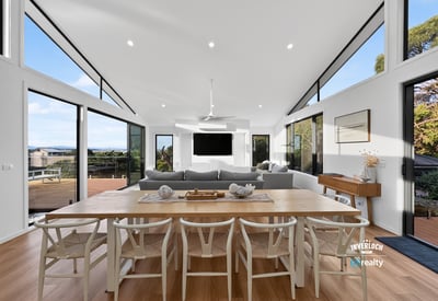 Contemporary open-plan living space featuring abundant natural light and stunning views, ideal for entertaining.