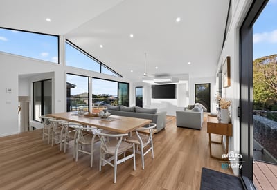 Bright, open living space features large windows, modern design, and seamless connectivity to outdoor views.