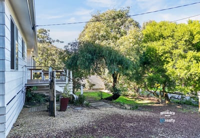 This property features a spacious outdoor area, perfect for relaxation and entertaining amidst lush greenery.