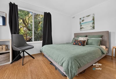Bright bedroom featuring large window with natural light, contemporary furnishings, and a relaxed, inviting atmosphere.