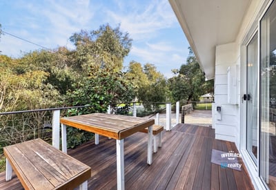 Expansive outdoor deck offers scenic views, perfect for entertaining or relaxing amidst nature.