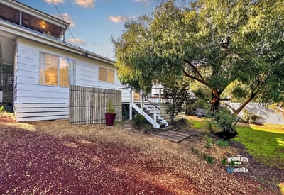 Cozy home with a spacious yard, perfect for outdoor activities and family gatherings.