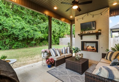 Covered outdoor living space with gas fireplace