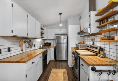 Modern kitchen featuring sleek cabinetry, butcher block countertops, and ample storage for all your culinary needs.