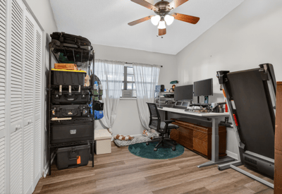 This versatile room offers ample storage, ideal for a home office or creative space.
