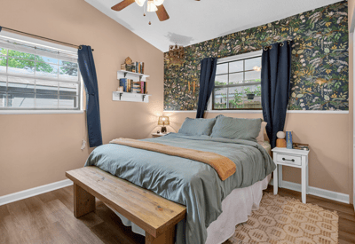 Cozy primary bedroom with ample natural light, perfect for relaxation.